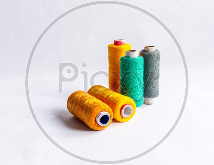 Threads for sewing of various colors on a white background isola Stock  Photo by ©avtor_hell 144177959