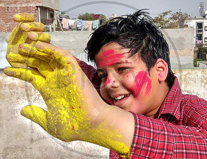 Holi (A Festival of Hindu Religion in India) also called Festival of color, Different Mood and expressions. Child or Kid playing Holi, New Delhi INDIA