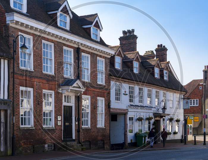 East Grinstead, West Sussex, Uk - March 1: View Of Offices And A Pub Closed Due To Coronavirus Pandemic In The High Street In East Grinstead On March 1, 2021. Two Unidentified People