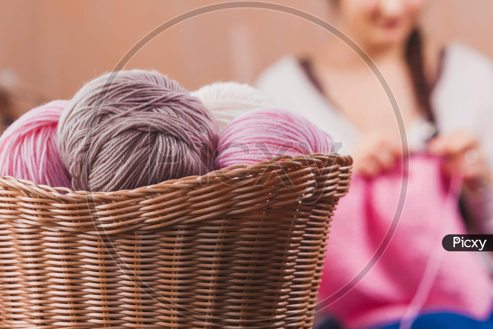 The Woman Knits Woolen Clothes. Knitting Needles. Close-Up. Natural Wool