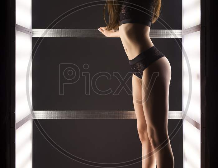 Fashion Photo Of Young Beautiful Woman In Underwear In Light In Dark Studio