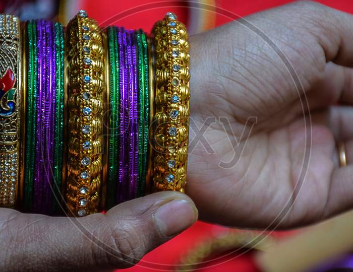 Stock Photo Of A Hand Of Indian Women Wearing Colorful Bangles With Gold Indian Design Bracelet, Picture Captured At The Time Of Indian Wedding Season At Bangalore Karnataka India.