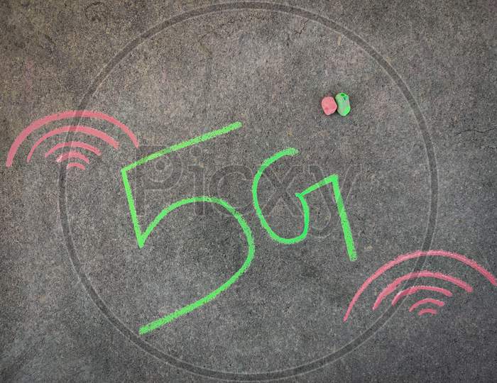 The Inscription Text On The Grey Board, 5G With Hand Drawn Waves. Using Color Chalk Pieces.Internet Concept