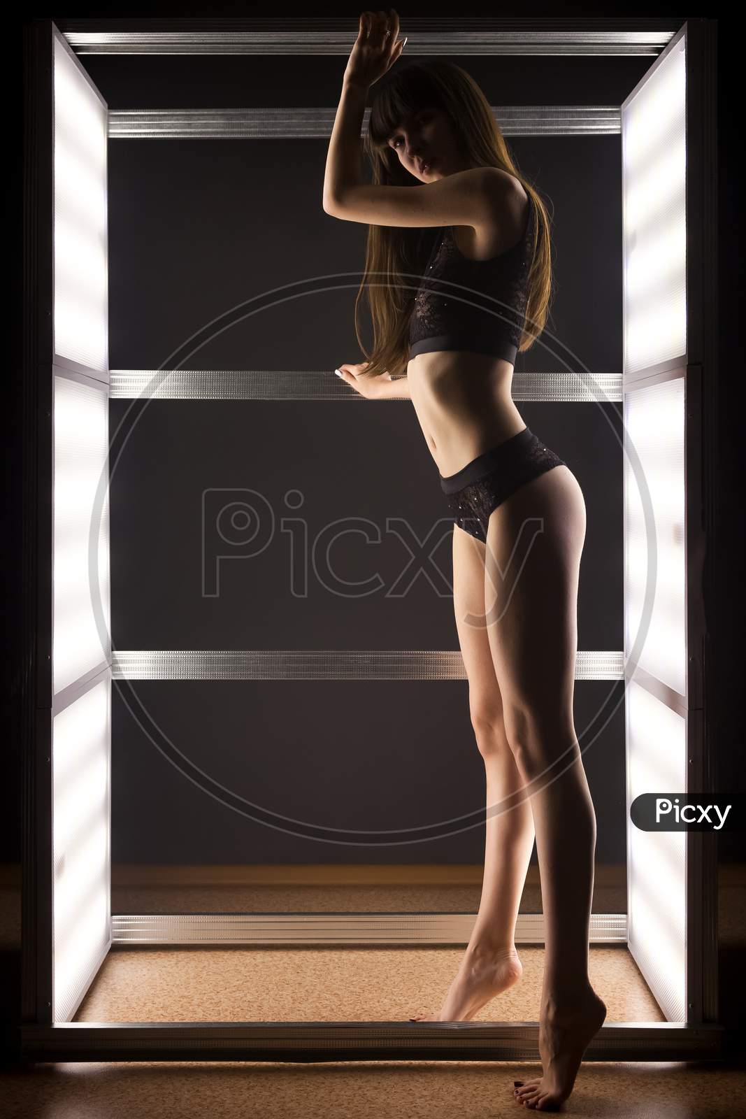 Fashion Photo Of Young Beautiful Woman In Underwear In Light In Dark Studio