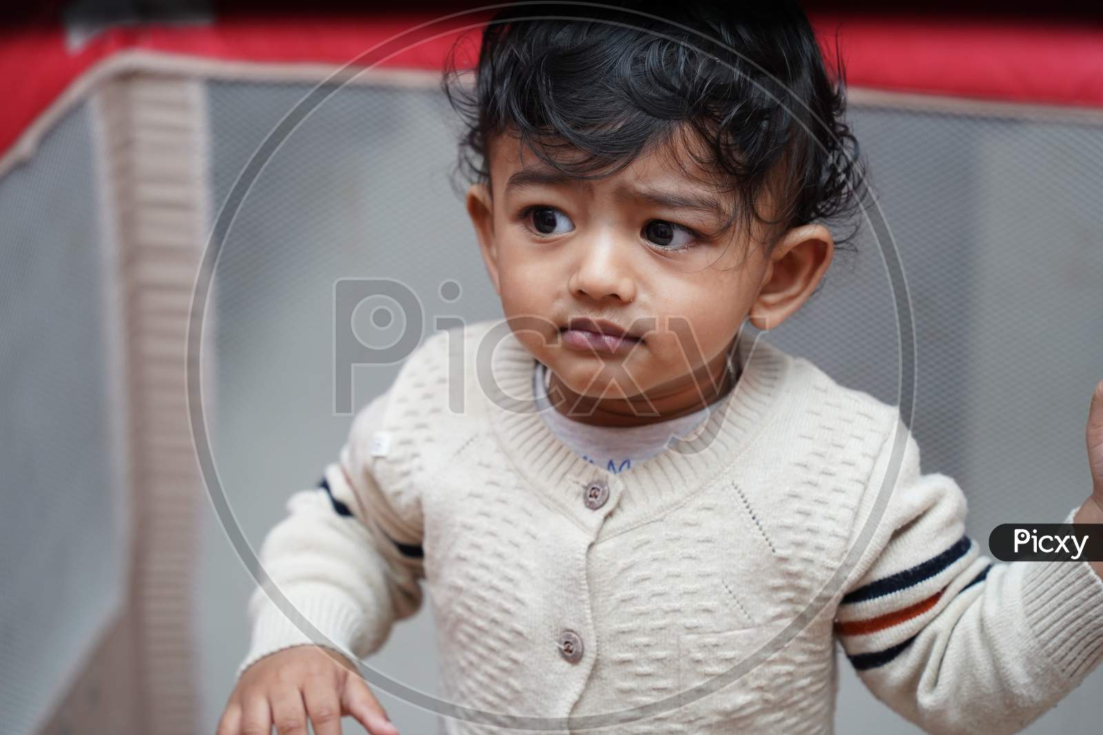 Closeup Photo Of An Adorable Baby Indian Boy With Worried Face