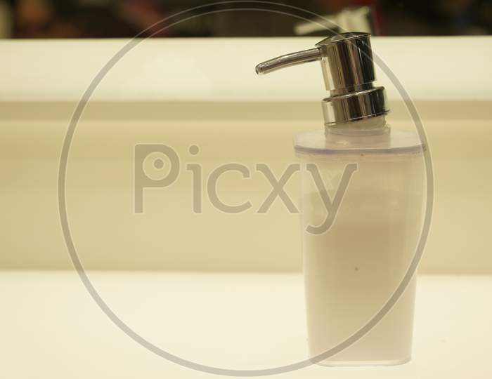 Close Up Image Of A Glass Soap Dispenser Squeezer With Steel Head
