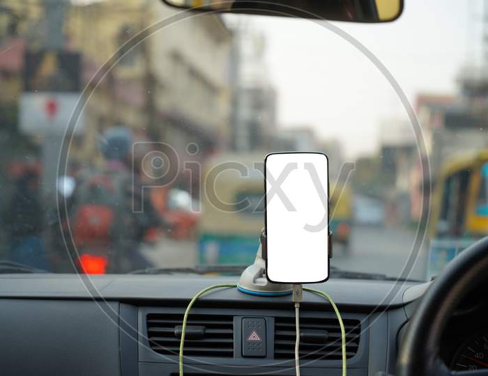 A Smartphone Held On A Dashboard Of A Cab Taxi With Mockup White Screen For Navigation