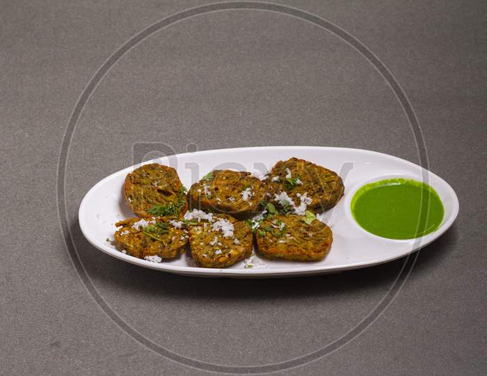 Cilantro Cake Or Kothimbir Vadi Is A Popular Maharashtrian Cuisine Made With Cilantro Leaves. Served With Tomato Ketchup. Selective Focus