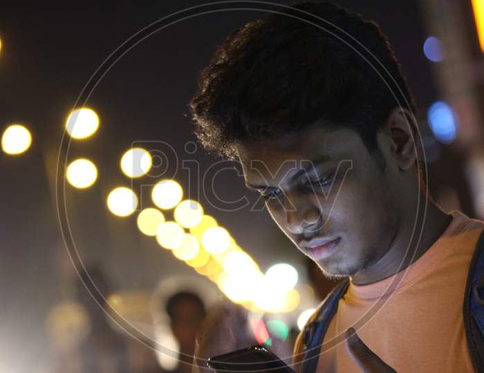 person at night seeing mobile