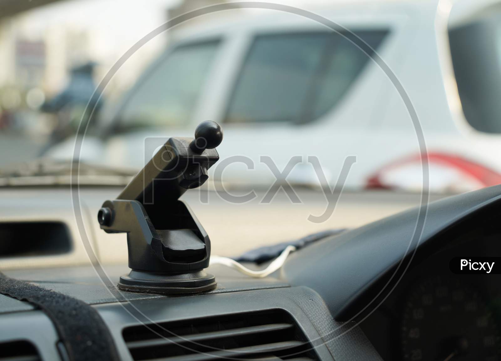 A Mobile Phone Holder In Dashboard Of A Car With Ball Joint System For Navigation