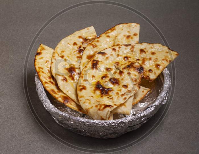 Indian Cuisine Tandoori Roti Also Served In Basket Including Chapati, Flatbread, Naan Or Nan Bread On Wooden Background