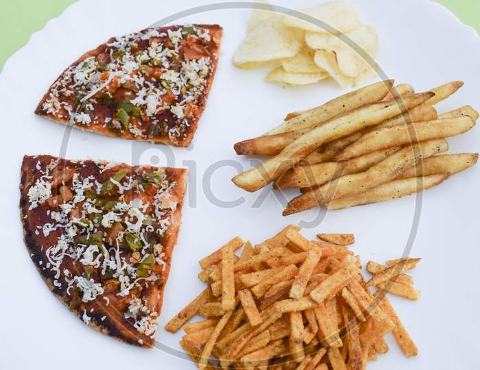Indian Fasting Upwas Items Eaten During Fesivals As Religious Belief. Snacks Like Potato Chips, Tikha Chivda, French Fries And Farali Pizza Made Of Fasting Dough.Breakfast Lunch Platter Mahashivratri