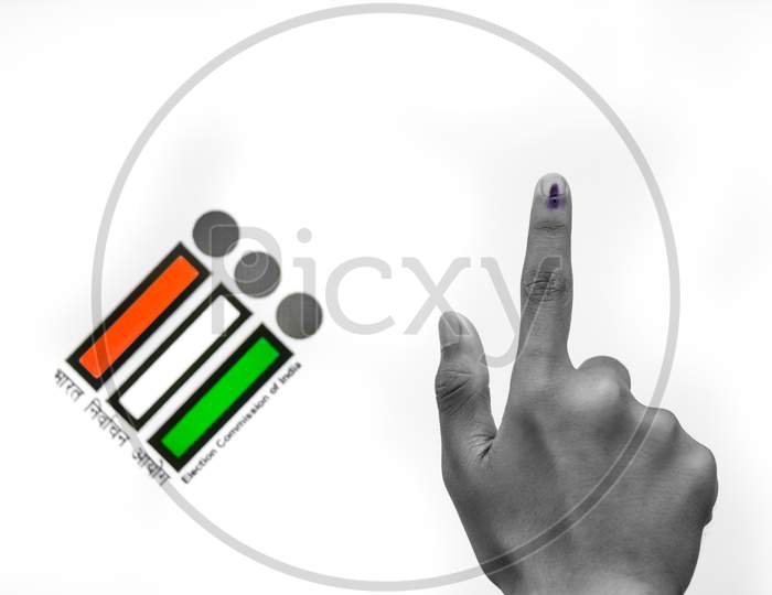 Indian Voter Hand With Voting Sign And Ink Pointing Vote For India Behind On Election Commission Of India Background.