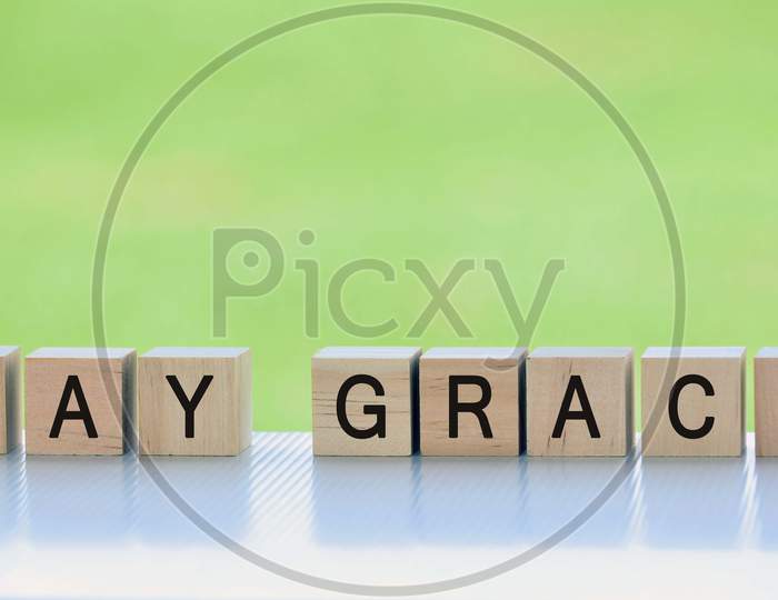 Say sorry text on wooden cube block with blurred green grass background