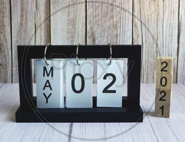 Text and numbers on wooden block cube and paper stand frame - Labor day concept