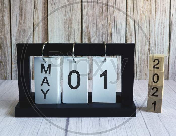 Text and numbers on wooden block cube and paper stand frame - Labor day concept