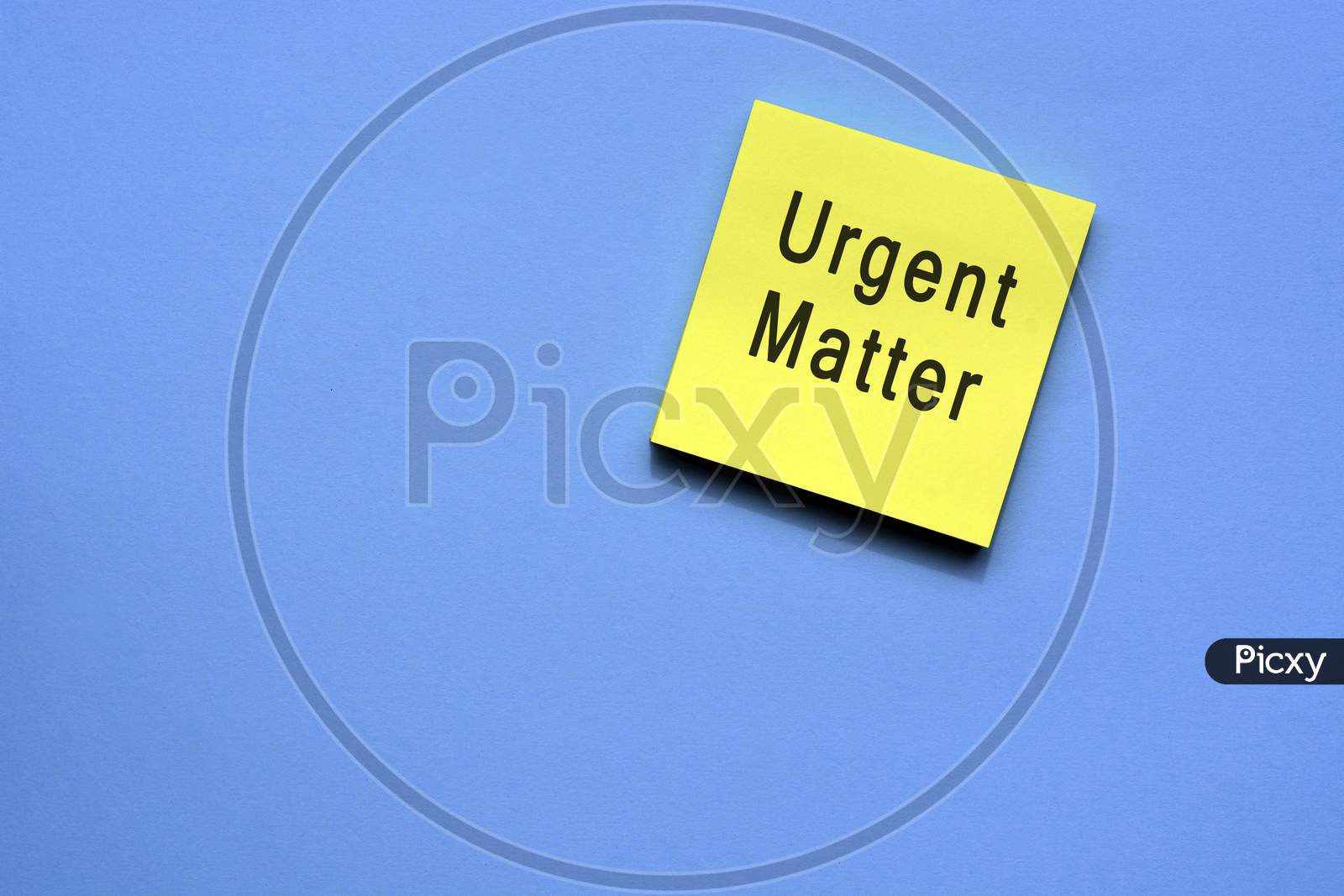 reminder text on yellow sticky note with blue background