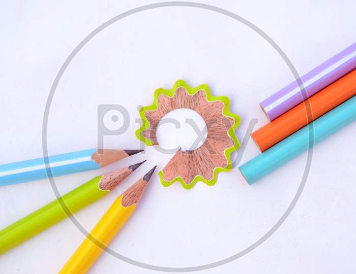 Bunch The Colorful Wooden Peels Pencils With Waste Flower Isolated On White Background.