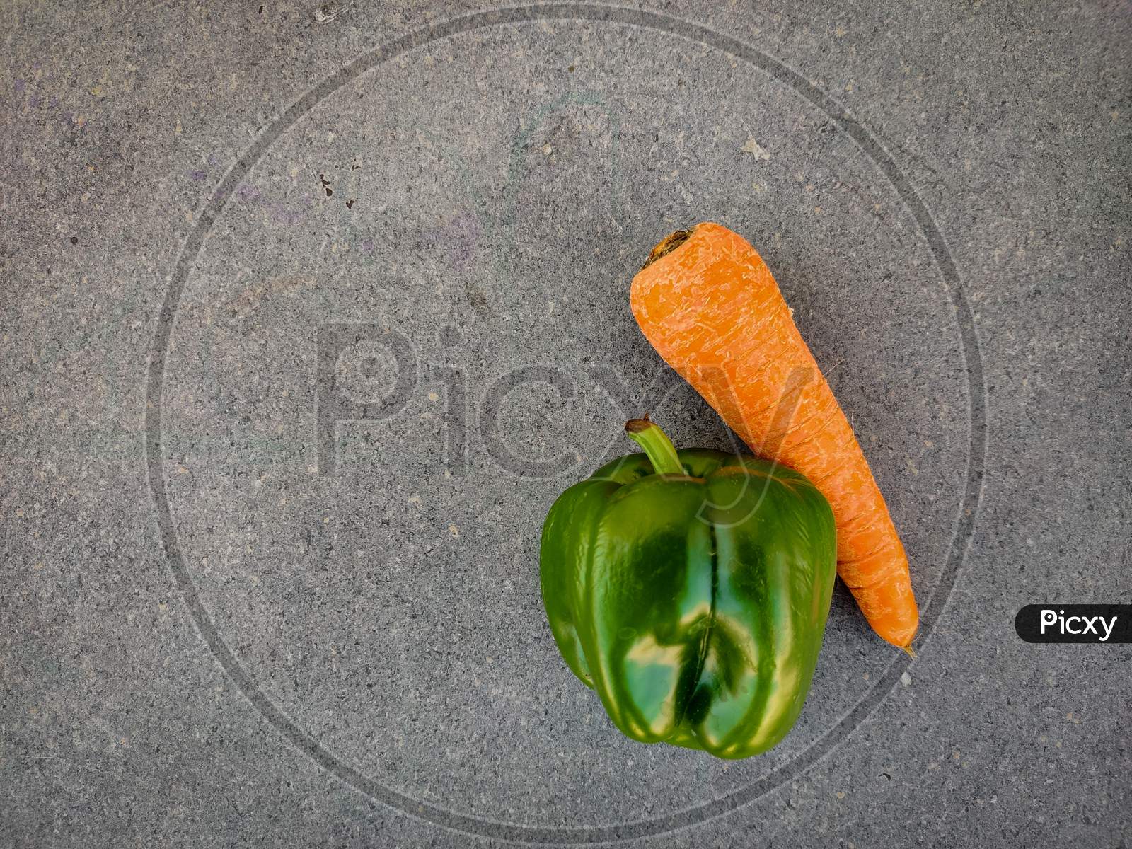 Top View Of Green Capsicum And Carrot Isolated On Grey Background