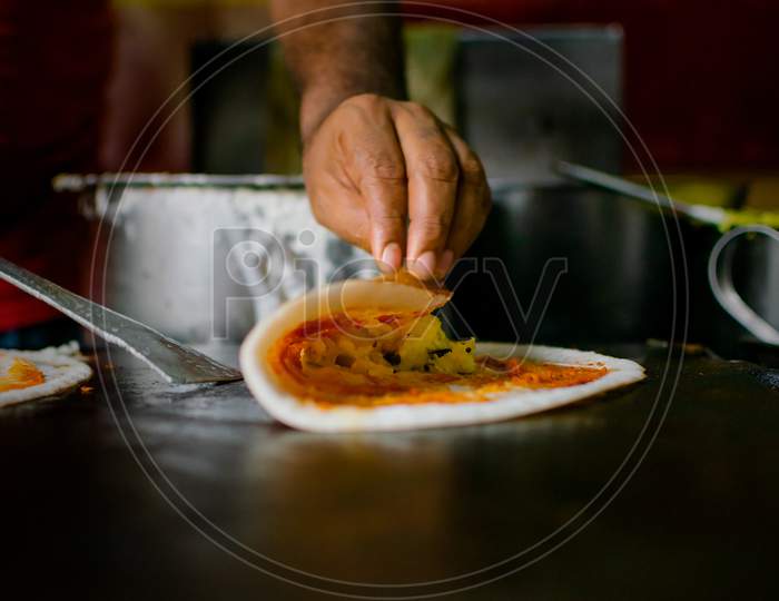 Making Of Masala Dosa On The Pan. Masala Dosai Or Masale Dose Or Masaldosa Is A Variation Of The Popular South Indian Dosa. Used Selective Focus.