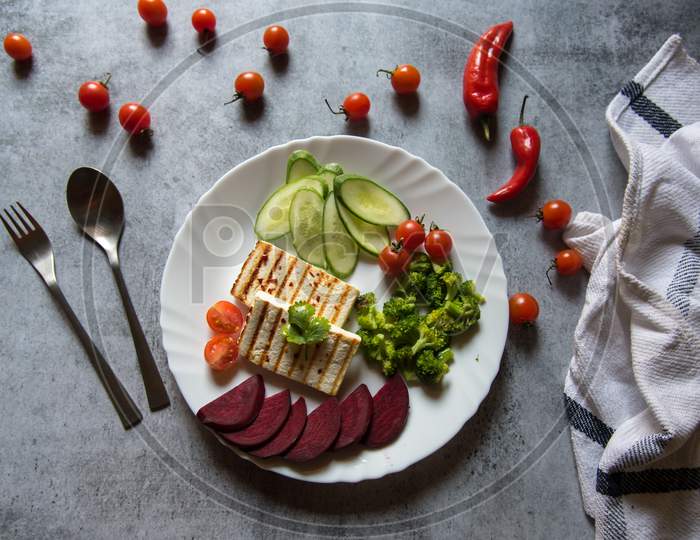 Continental preparation of cottage cheese grilled with boiled vegetables