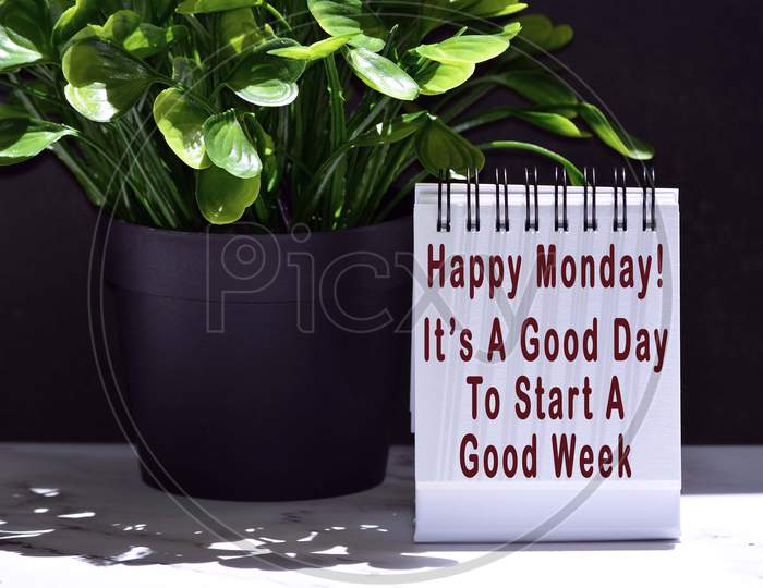 Text on notepad with plant and dark background - Happy Monday, it is a good day to start a good week