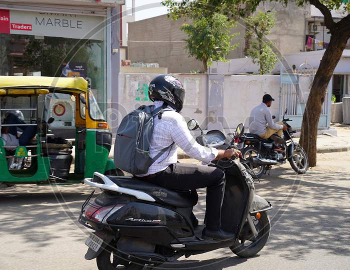 Motorcycle Rider On Bike On Road. An Adult Biker Passing Through Road In Metropolitan City Jaipur.
