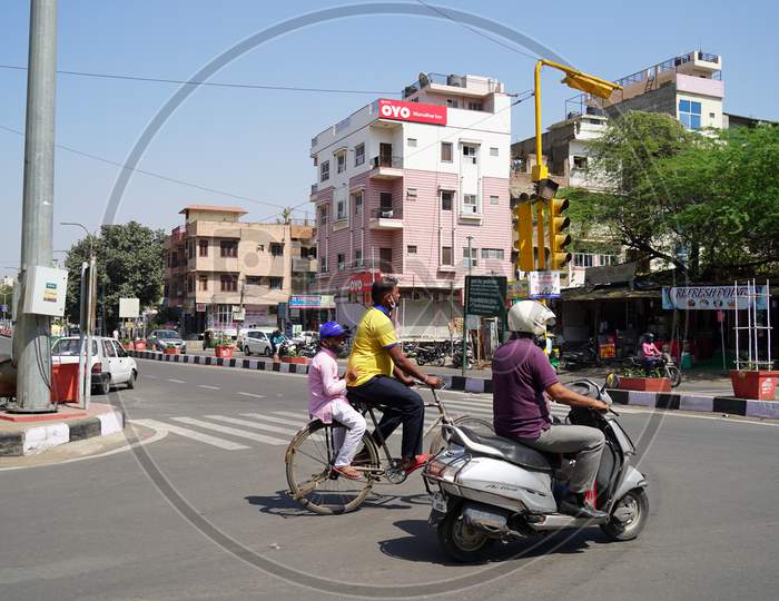 Daily Traffic Life Concept. Two Indian Man Crossing Road With His A Kid On A Asphalt Road.