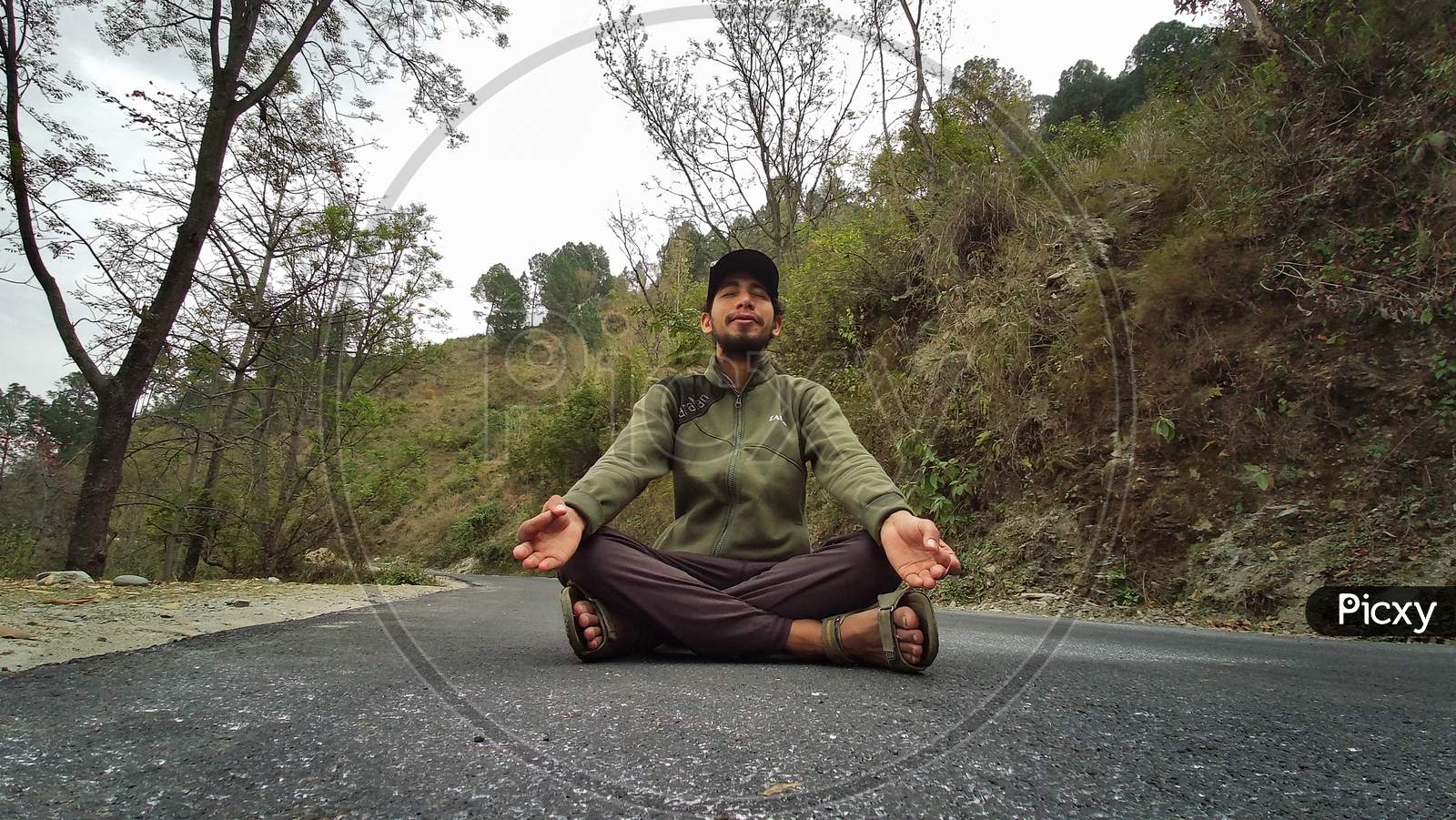 A BOY DOING YOGA ON THE ROAD