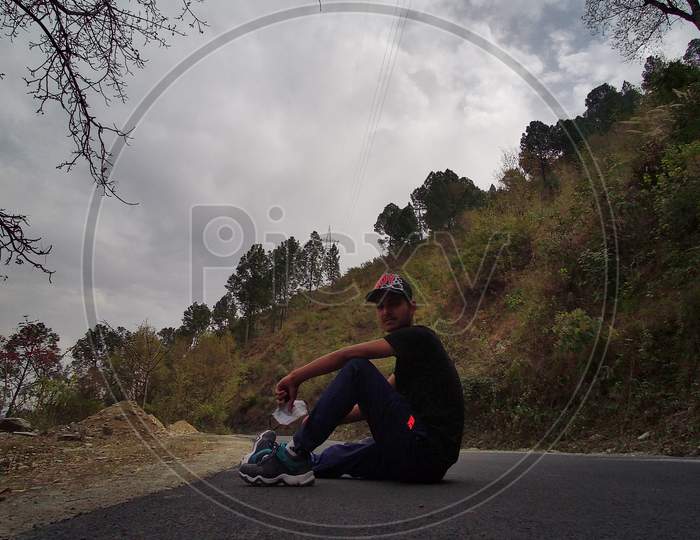 A BOY SET ON THE ROAD AROUND MOUNTAINS