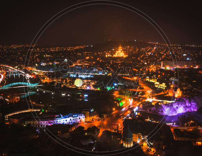 Tbilisi Night City Panorama With Passing Cars Sightseeing Attractions. Travel Georgia Blank Space Background