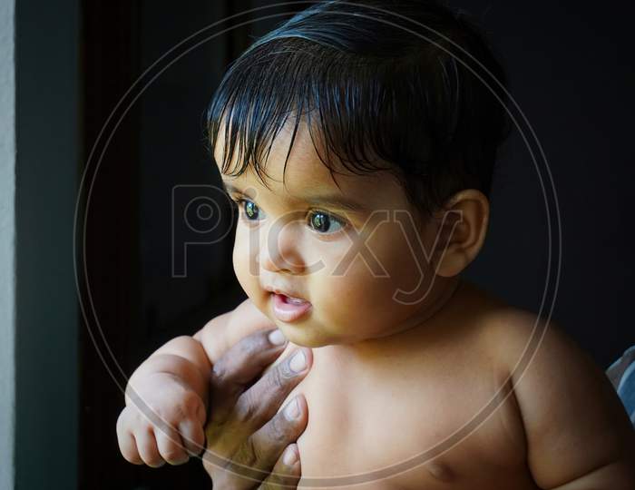 One-Year-Old Indian Baby Girl In The Hands Of Her Grandfather
