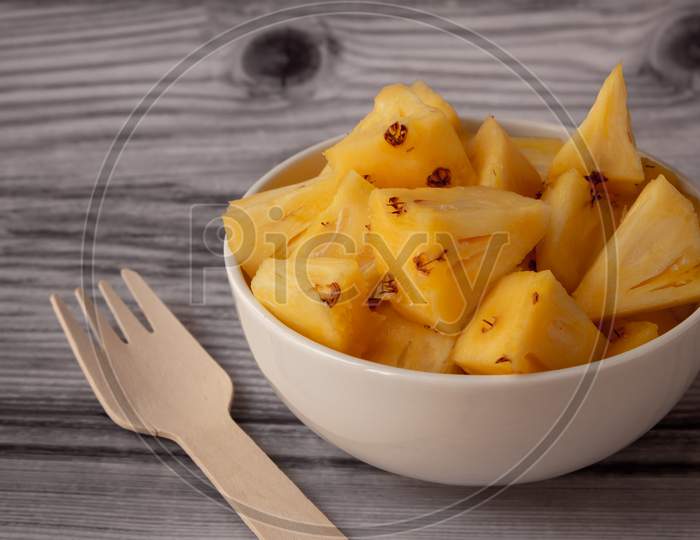Pineapple Skin Removed And Sliced Into Small Pieces. Pineapple Is Healthy And Good In Vitamins. Use For Healthy Snack Concept.