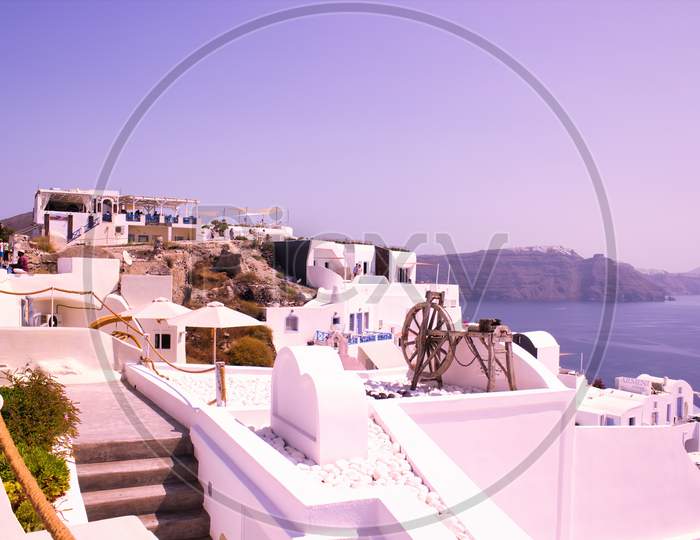 Santorini, Greece - September 11, 2017: Traditional Spinning Wheel Kept On A Roof As Decoration In Oia, Thira, Cyclades Islands, Greek Islands, Eu, Europe