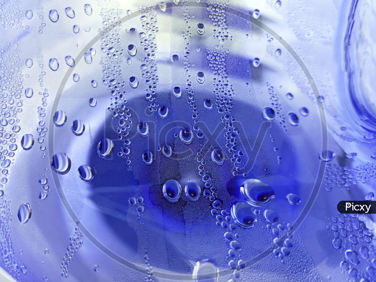 Water Drops View Through Transparent Bottle