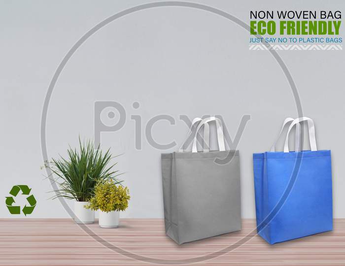 Empty Mockup Bags Isolated On Table With White Background. Eco Bags. Copy Space For Text.