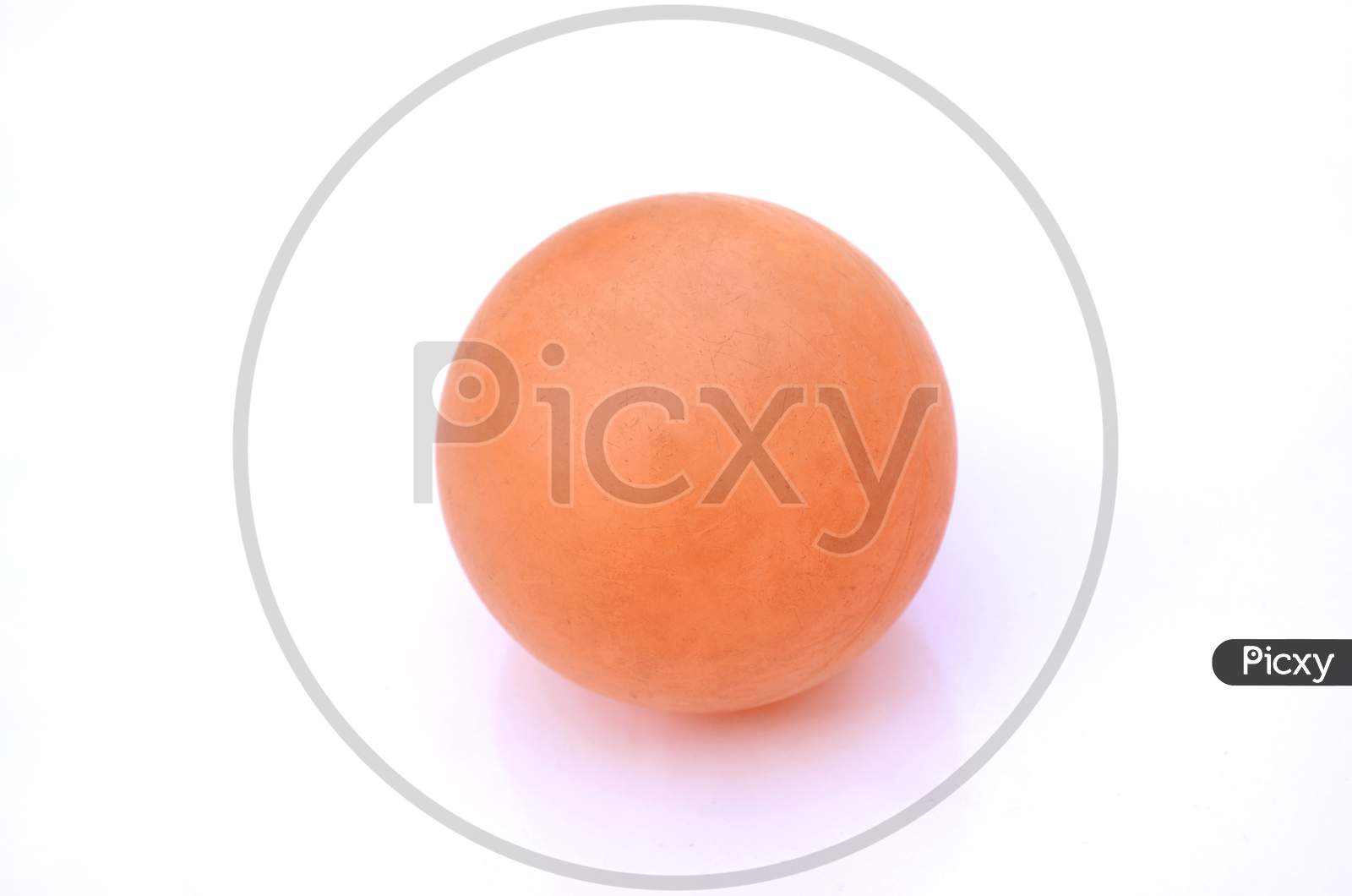 The Orange Color Old Cricket Ball Isolated On White Background.