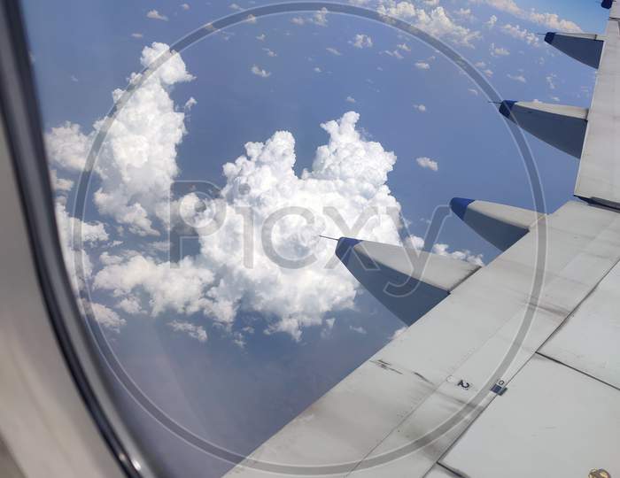 Airplane flying high in the sky touching clouds. beautiful scene of blue sky and white cloud