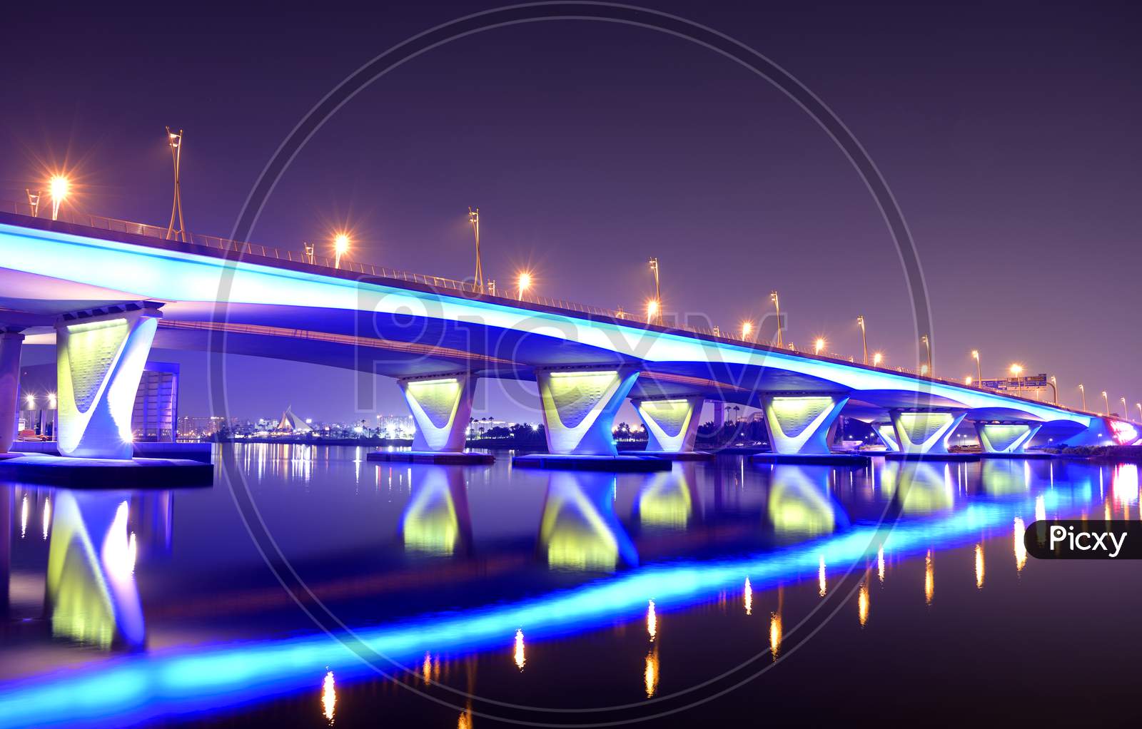 5Th November 2020 Dubai Uae. Beautiful Winter Night View Of The Blue Illuminated Al Gharhoud Bridge In Dubai, United Arab Emirates With The Colorful Reflection On The Water.