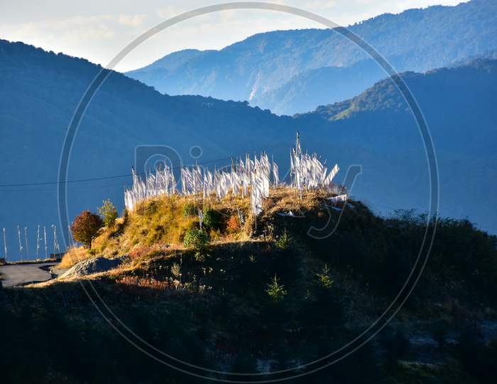 Hill Top In Morning Sunlight With White Prayer Flags