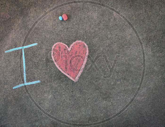 The Inscription Text On The Grey Board, I With Hand Drawn Love Symbol. Using Color Chalk Pieces.