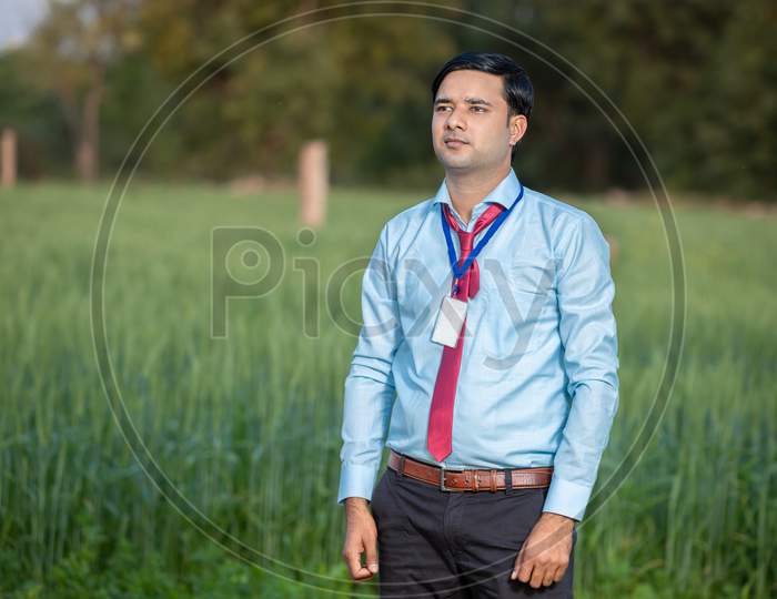 Portrait Young Indian Banker Or Agronomist Standing At Agriculture Field. Copy Space.