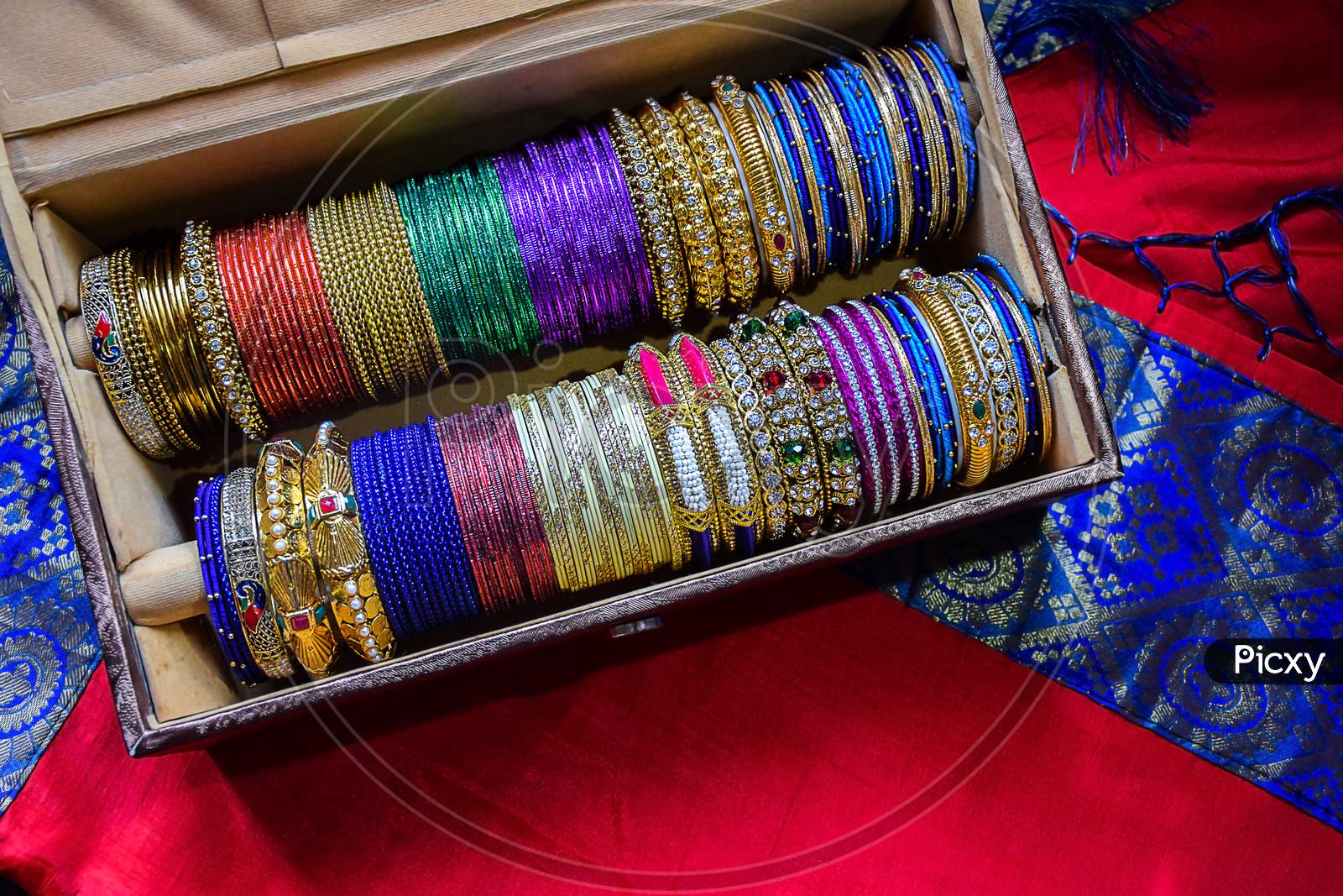 Stock Photo Of Indian Traditional Colorful Bangles And Bracelet Kept And Decorated In Bangle Box On Red Background, Focus On Object At Bangalore Karnataka India.