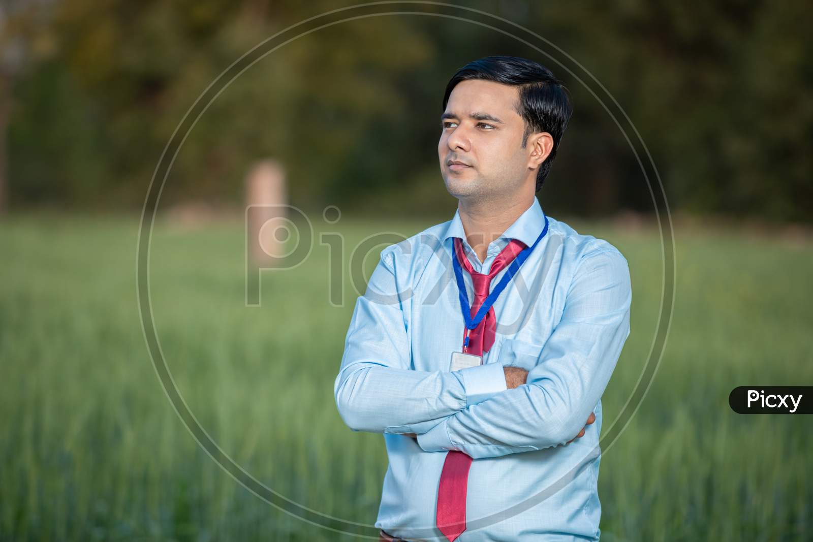 Portrait Young Indian Banker Or Agronomist Standing At Agriculture Field. Man Standing Crossed Arm, Copy Space.