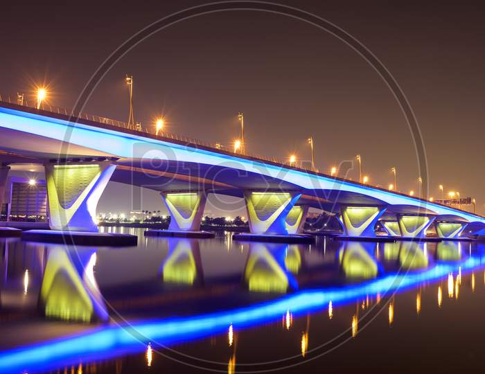 5Th November 2020 Dubai Uae. Beautiful Winter Night View Of The Blue Illuminated Al Gharhoud Bridge In Dubai, United Arab Emirates With The Colorful Reflection On The Water.