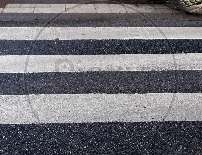 White Painted Pedestrian Zebra Crossing On A Road In Europe.