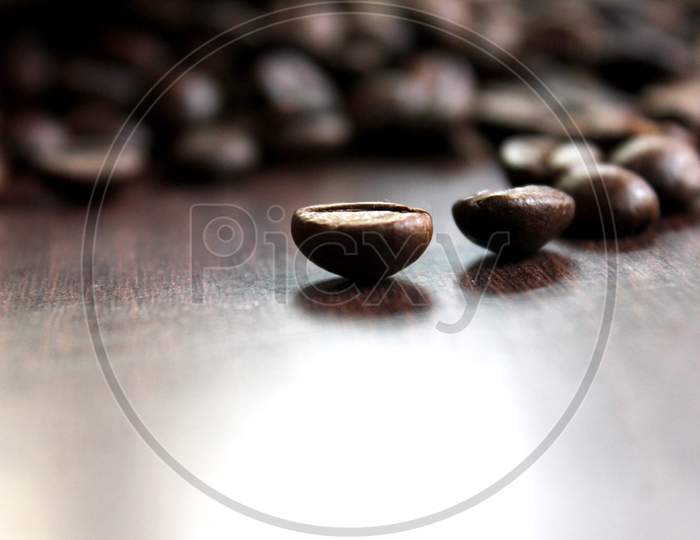 Closeup Of Roasted Coffee Beans On Top Of The Table