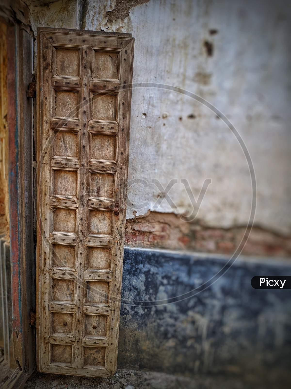 Vintage Old Warehouse Wooden Brown Painted Door With Ancient Brick Wall Of Limestone. Front View Of Gates To Abandoned Warehouse In India