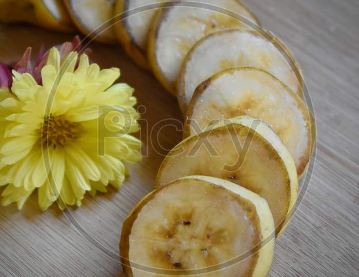 Whole And Sliced Bananas Isolated On Wooden Board With Copy Space For Your Text. Top View. Flat Lay