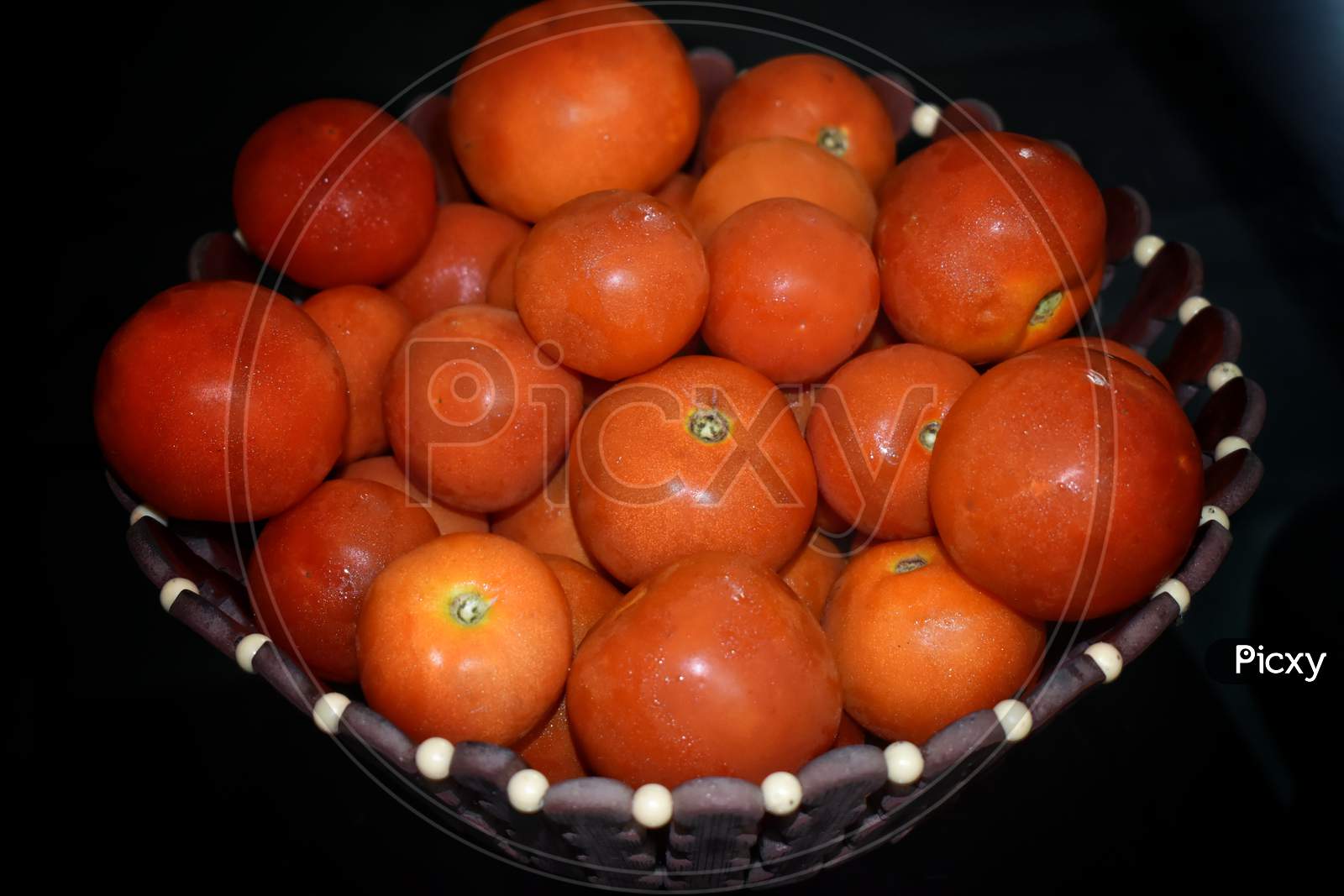 Fresh Tomatoes In A Plate On A Dark Background. Harvesting Tomatoes. Top View